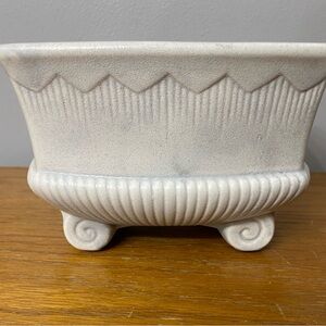 Mid-century modern McCoy pottery planter with scrolled feet and ribbed base.